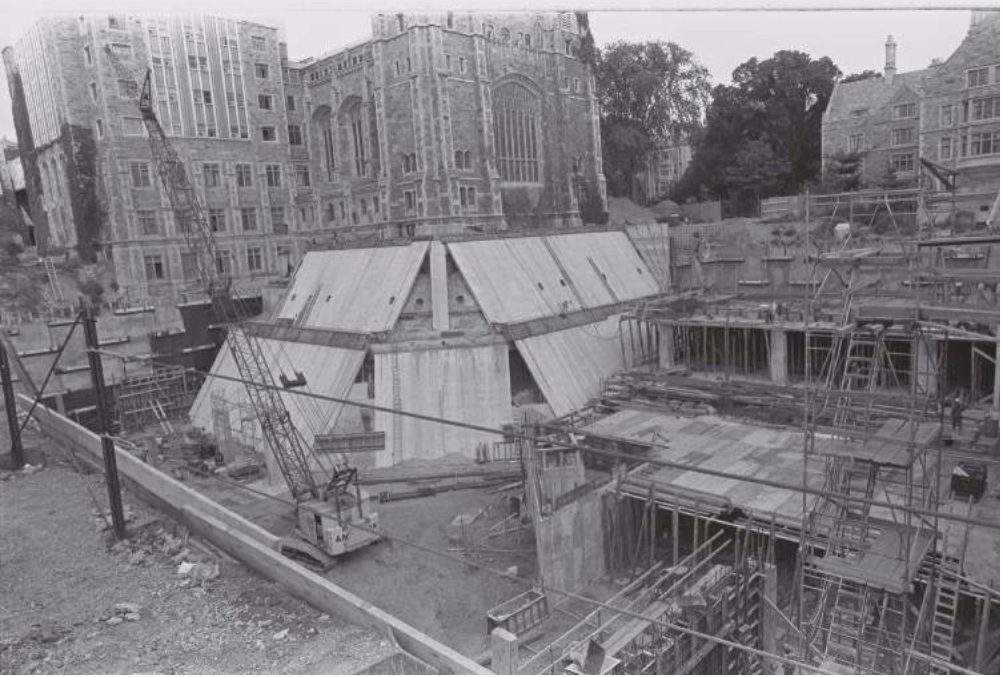 Construction of the Underground Law Library in 1979, with the Gothic Legal Research building standing above the open excavation